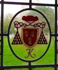 Kempe arms in stained glass Wye College Chapel 